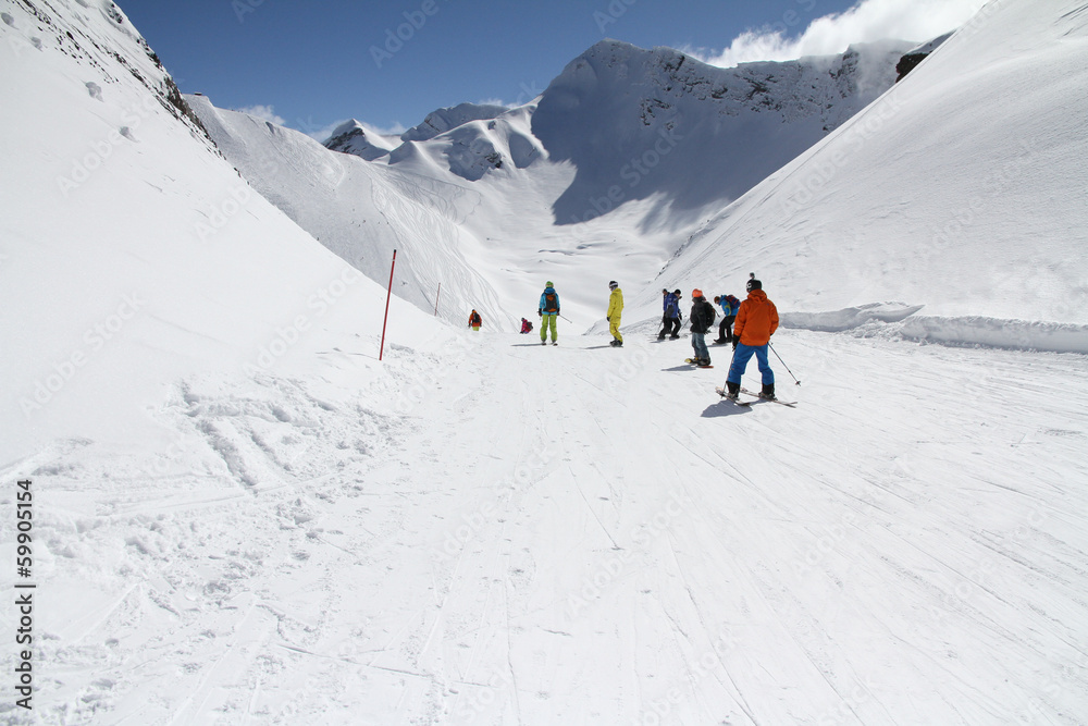 Skiers going down the slope at ski resort