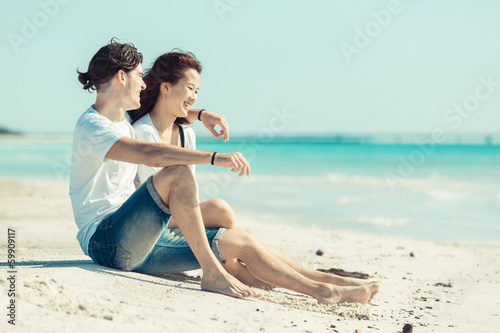 Young Couple Sitting in a Caribbean Beach