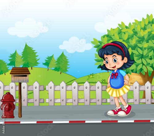 A pupil at the street near the mailbox