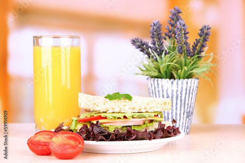 Fresh and tasty sandwich on plate on table on light background