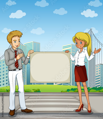 A man and a woman at the pedestrian lane holding an empty signbo