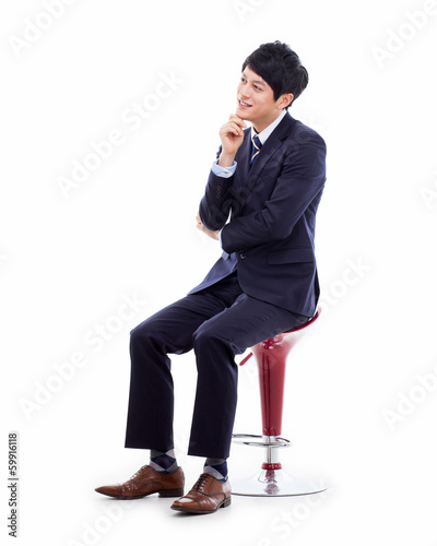 Young Asian business man sitting on the chair