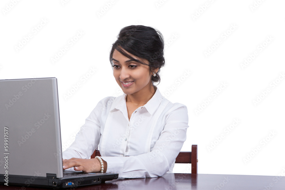 Attractive Asian businesswoman using laptop at her desk Attractive Asian businesswoman using laptop at her desk