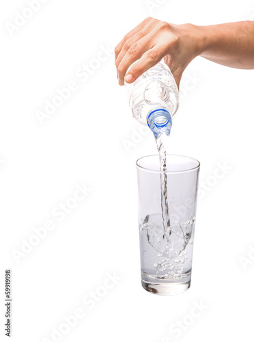 Female hands pouring water into a glass