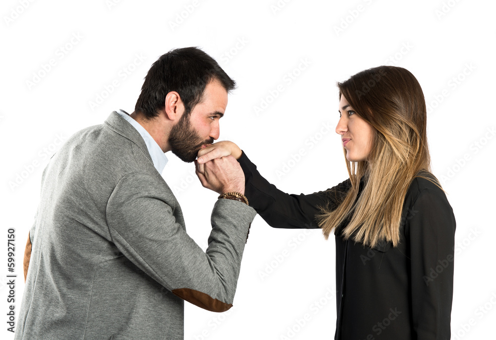 man kissing a woman's hand over white background. man kissing a woman's hand over white background.
