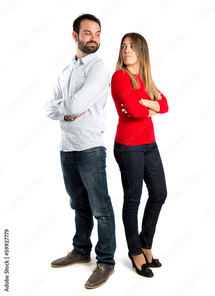 Couple with their arms crossed over isolated background Couple with their arms crossed over isolated background