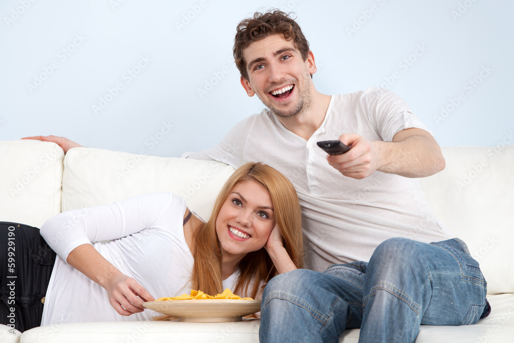 Young couple watching tv at home Young couple watching tv at home