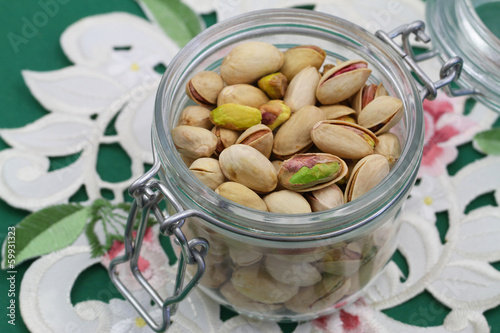 Pistachio nuts in vintage jar, close up