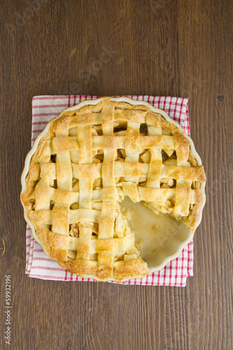 Apple pie with lattice top with slice taken
