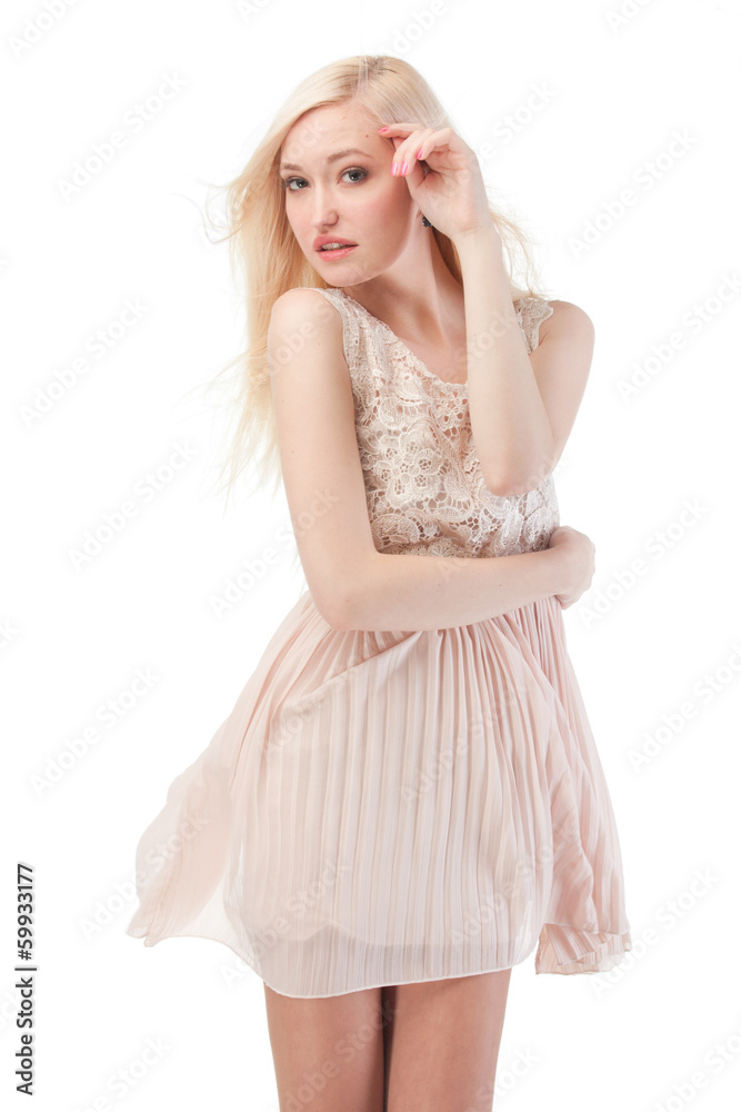 Sexy blonde woman posing with wind in the hair and dress