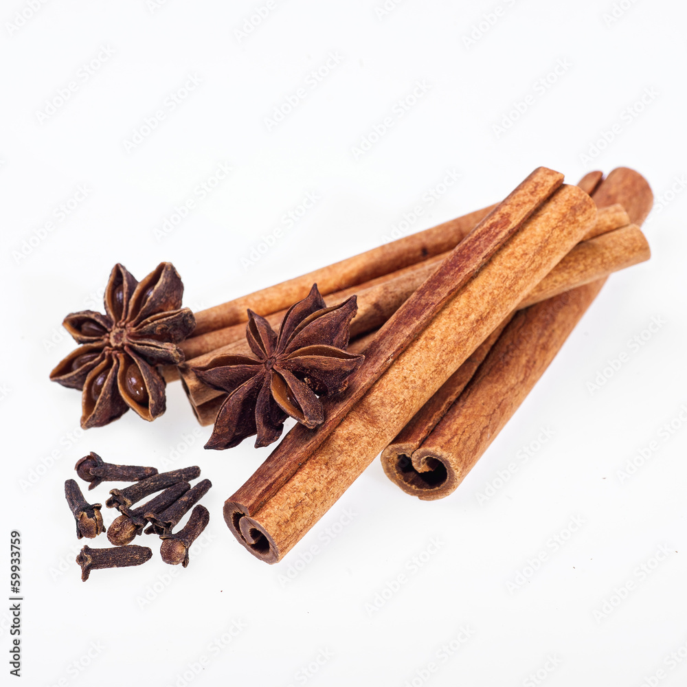 Cinnamon, anise and cloves on white background Cinnamon, anise and cloves on white background