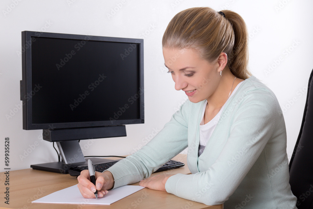 young secretary doing paperwork in office