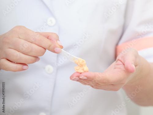 Beautician hands with moisturizing cream. Skincare.