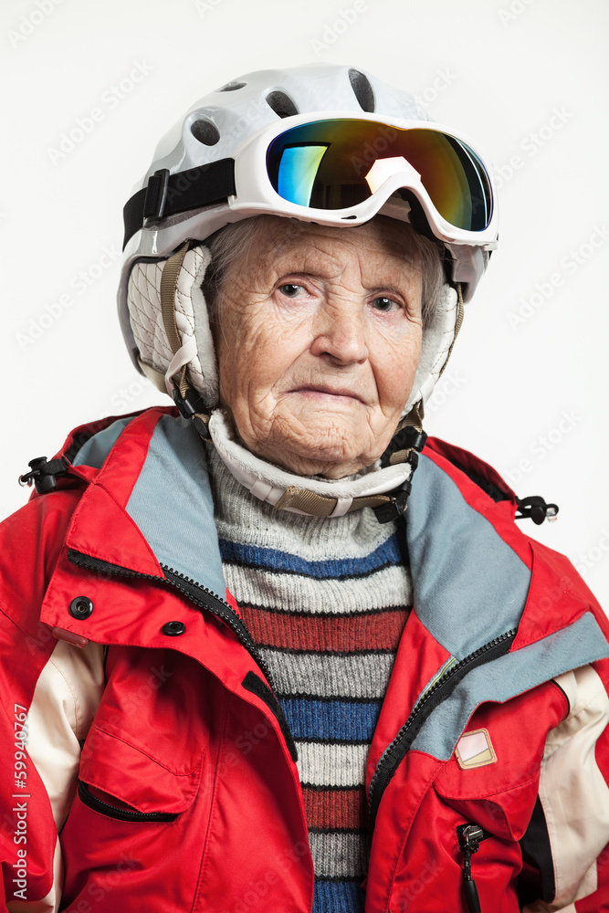 Portrait of senior woman in ski jacket and helmet over white Portrait of senior woman in ski jacket and helmet over white
