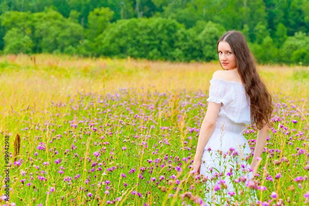portrait of a beautiful brunette in a field of purple flowers portrait of a beautiful brunette in a field of purple flowers