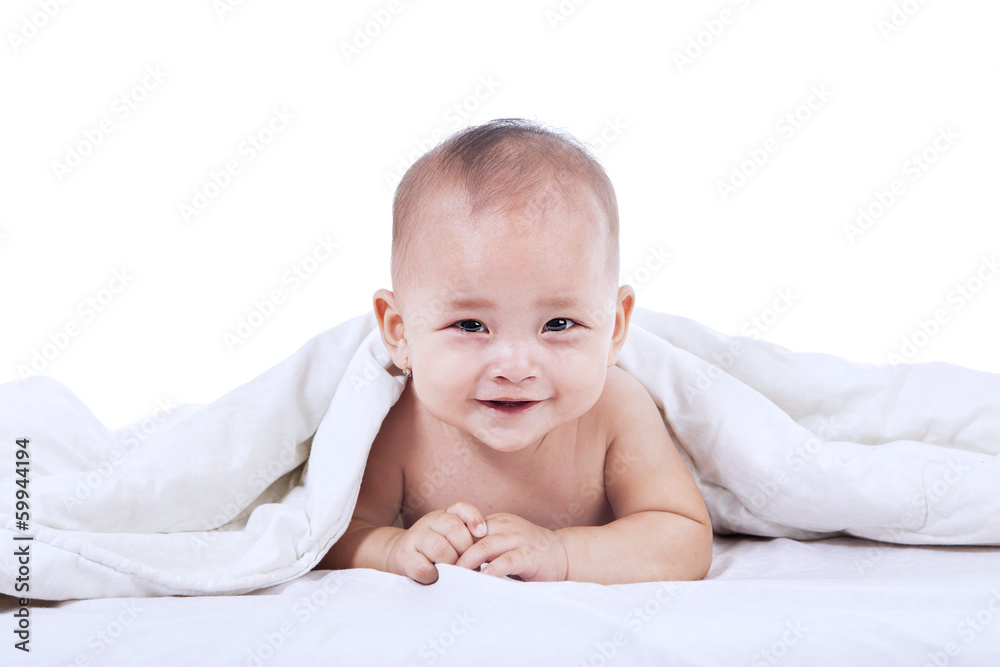 Cute baby laughing under blanket