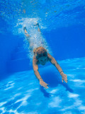 Underwater woman in swimming pool.