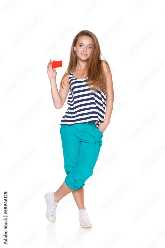 Positive teen girl smiling showing credit card Positive teen girl smiling showing credit card