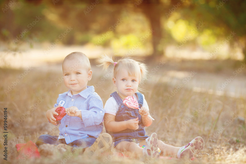 cute boy and girl playing together summer outdoors cute boy and girl playing together summer outdoors