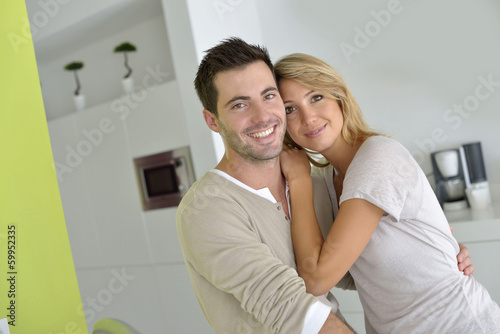 Middle-aged couple standing in home kitchen