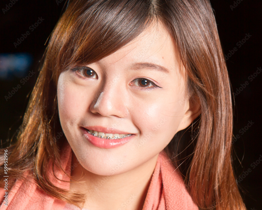 Pretty Asian woman with city lights in background Pretty Asian woman with city lights in background
