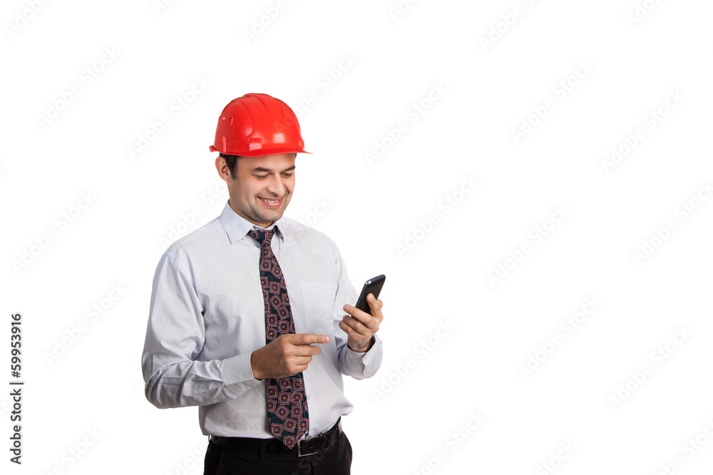 engineer in a red helmet with a mobile phone engineer in a red helmet with a mobile phone