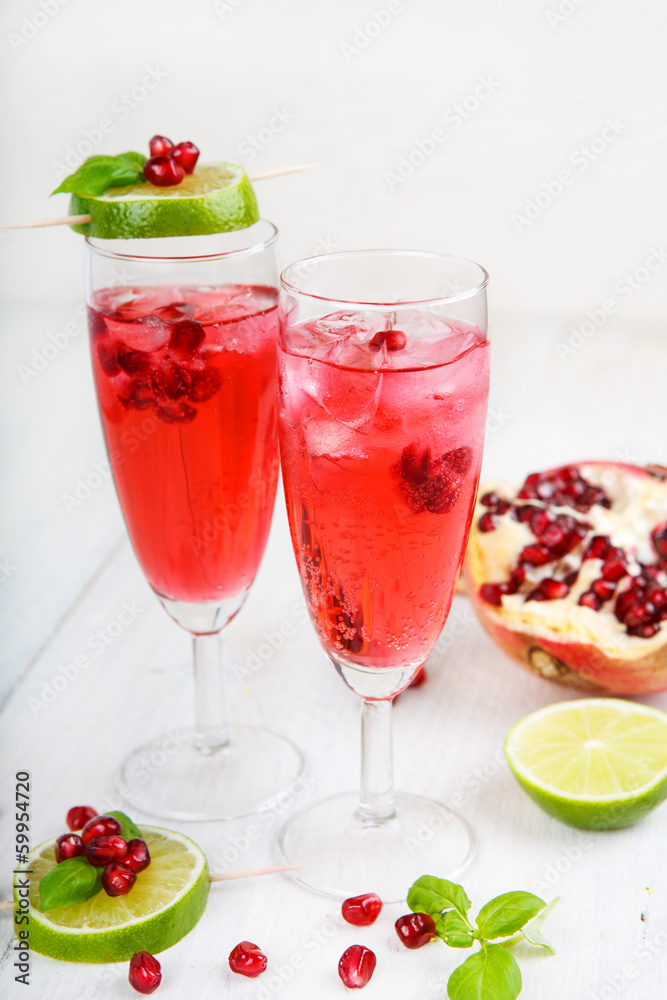 Two glasses with red pomgranate champagne, lime and mint. Two glasses with red pomgranate champagne, lime and mint.