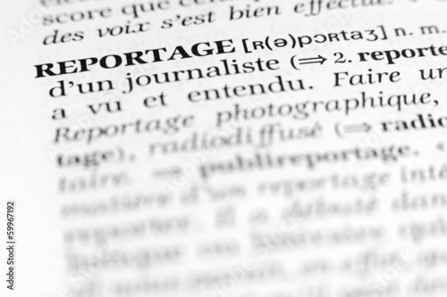 Close-up view of the word “reportage” printed in a French dictionary, captured with selective focus to illustrate journalism, news reporting, and media concepts
