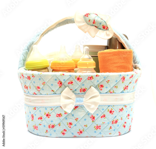 diapers milk bottle and flask in basket isolated on white backgr