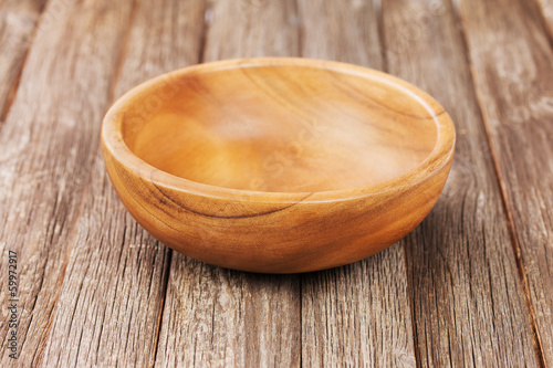 Empty bowl on old wooden surface.