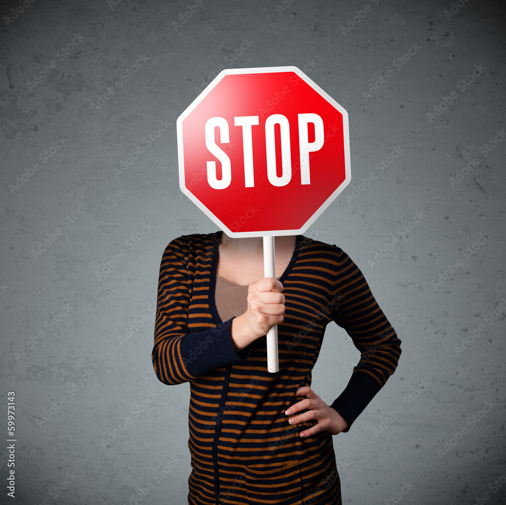 Young woman holding a stop sign Young woman holding a stop sign