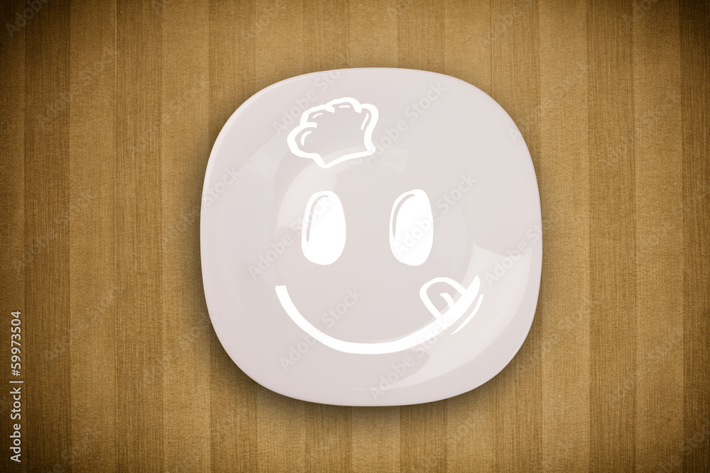 Happy smiley cartoon face on colorful dish plate Happy smiley cartoon face on colorful dish plate