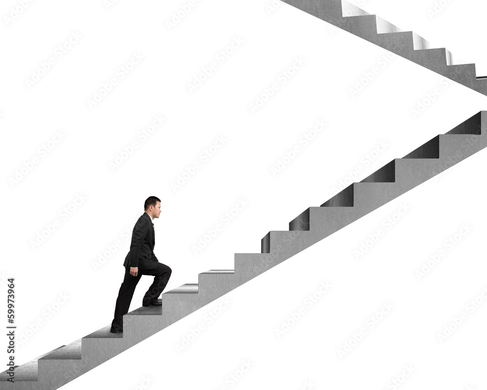 Businessman climbing on concrete stairs