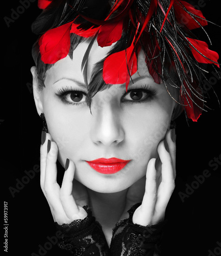 Fashion girl with feathers. Young woman with red lipstick