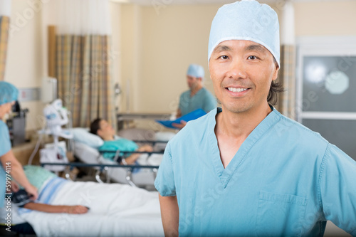 Canvas Print Smiling Male Nurse Standing In Hospital Ward