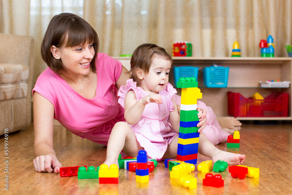 mother and her daughter play with toys at home interior mother and her daughter play with toys at home interior