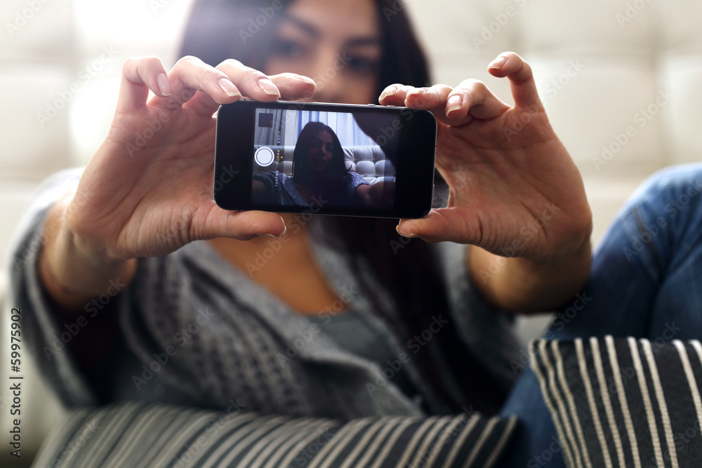 woman making self photo with smartphone. Focus on phone woman making self photo with smartphone. Focus on phone