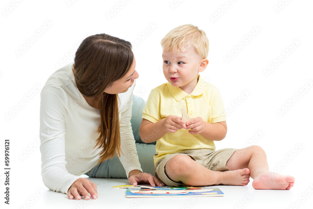 child boy and mother play together with puzzle toy child boy and mother play together with puzzle toy