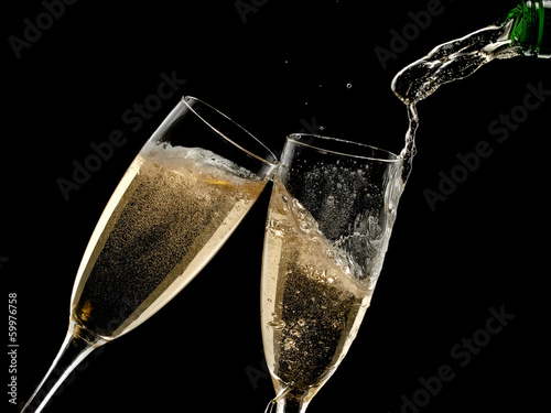 Two champagne glasses pouring