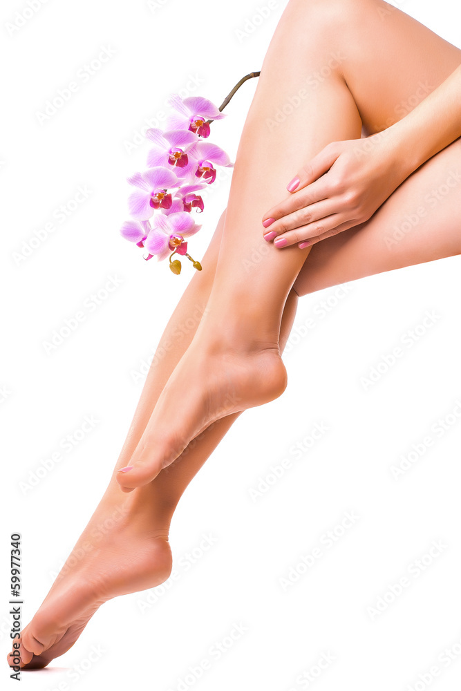 female legs and pink manicure with orchid flower female legs and pink manicure with orchid flower