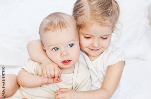 happy little sister hugging her brother