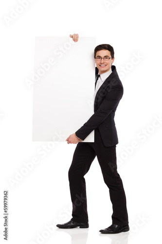 Cheerful male office worker standing with placard.