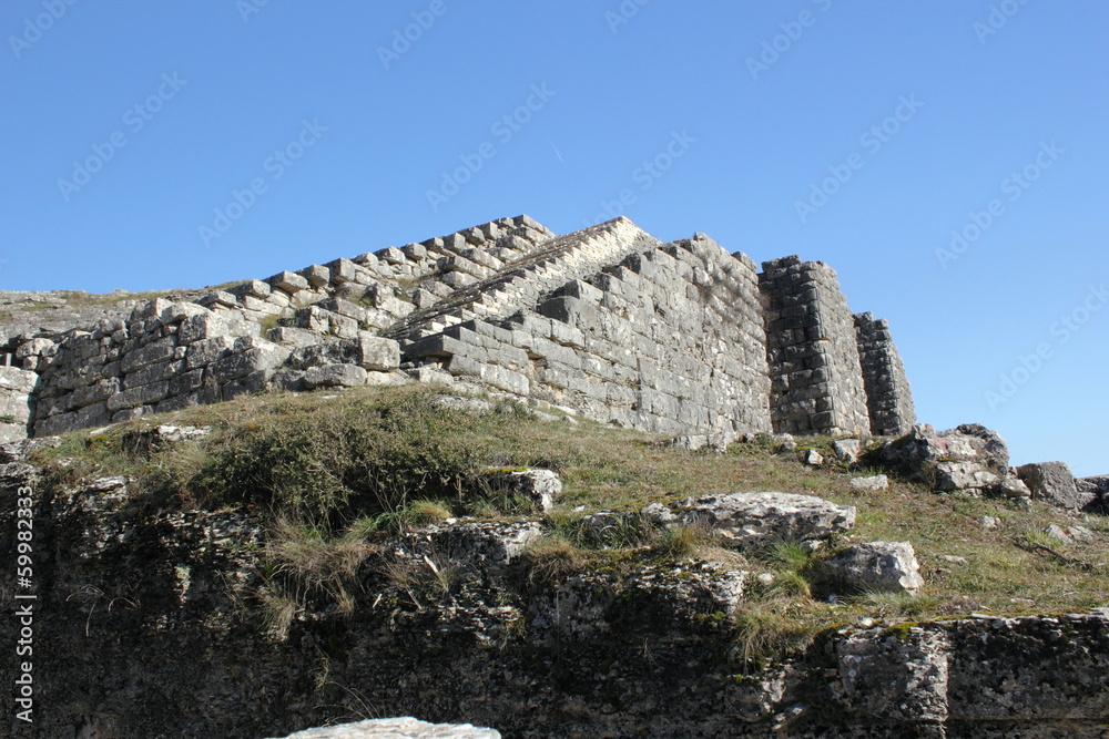 Ancient archaeological site amphitheater or amphitheatre  in Dodoni in Greece with stone seats and steps