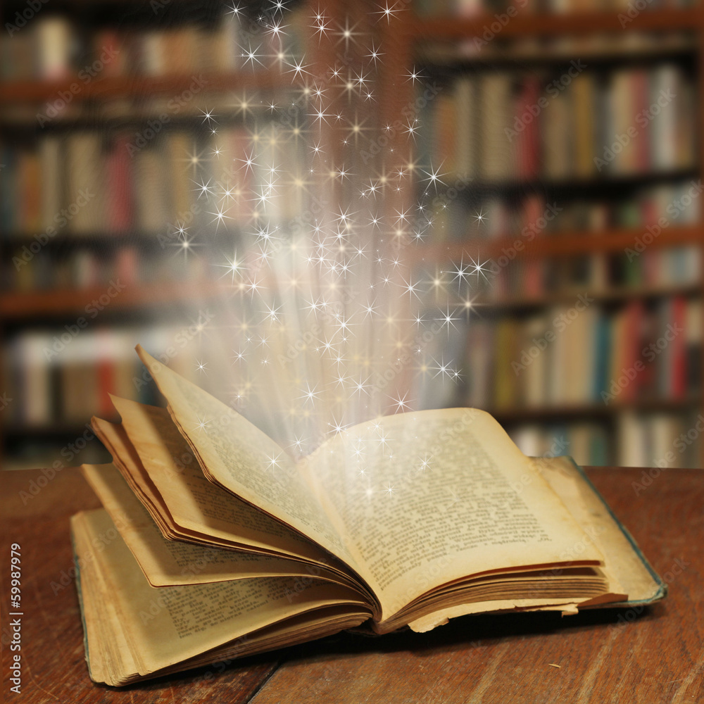 Opened magic book with magic light