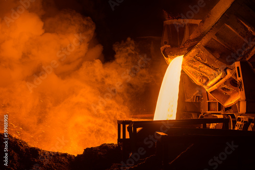Hot steel pouring in steel plant photo