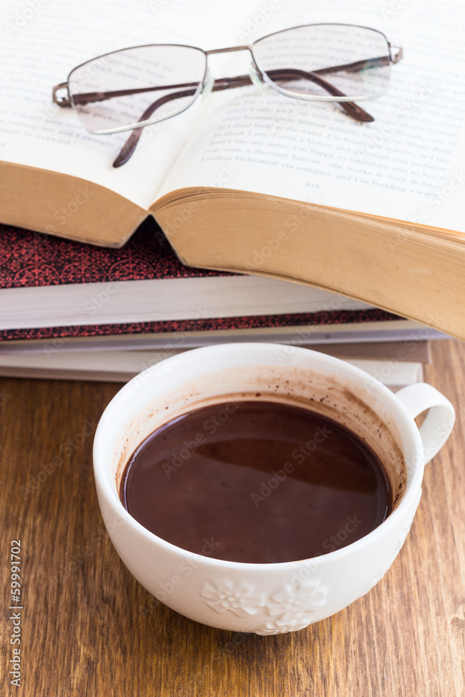 Cup of chocolate on a wooden table with books with books Cup of chocolate on a wooden table with books with books