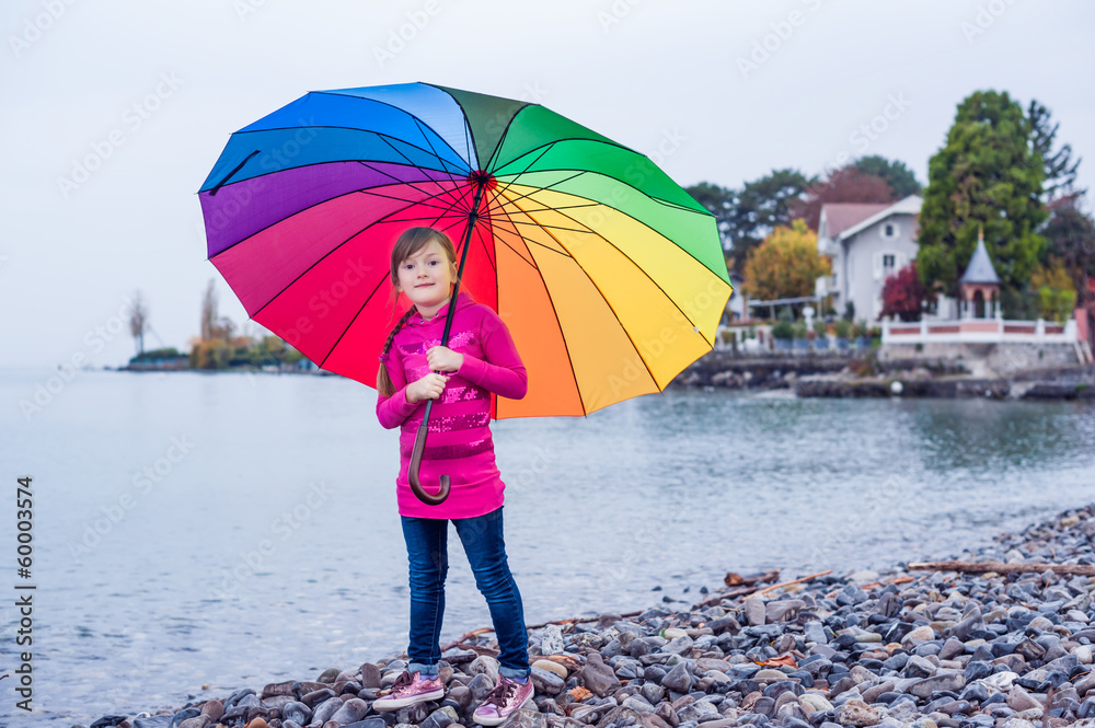 Φωτογραφία Portrait of a cute little girl with big colorful umbrella