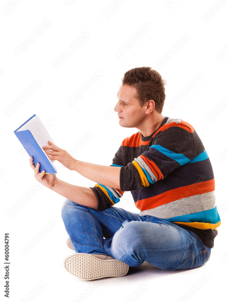 Fototapeta premium male student reading a book preparing for exam