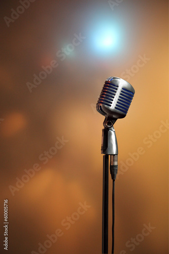 Stylish retro microphone on a colored background photo