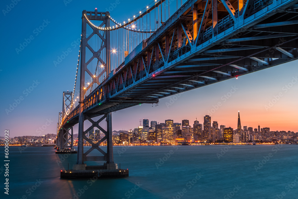 San Francisco skyline framed by the Bay Bridge at sunset - obrazy, fototapety, plakaty 